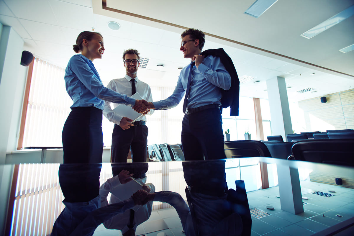 businesspeople-shaking-hands-workplace